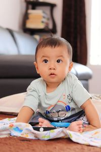 Cute baby boy sitting at home