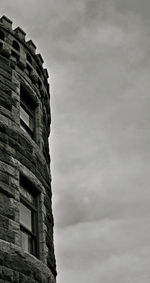 Low angle view of building against cloudy sky