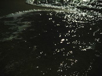 Close-up of reflection in water at night