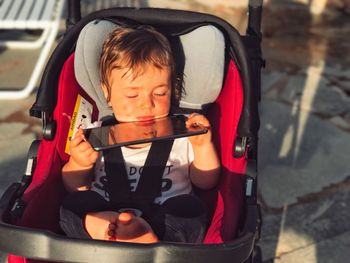 Baby with digital tablet in stroller