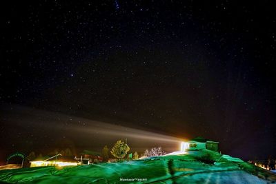 Illuminated building against star field at night