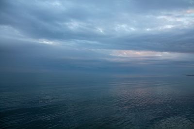 View of calm sea against cloudy sky