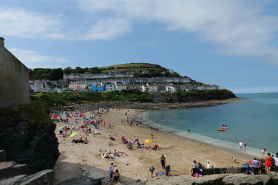 People on beach against sky