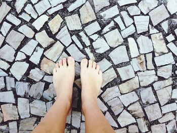 Low section of woman standing on tiled floor