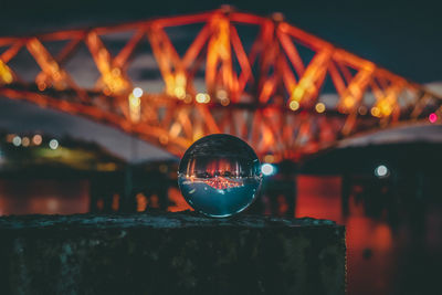 Close-up of illuminated bridge against sky at night