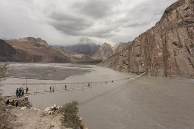 High angle view of people on suspension bridge over river