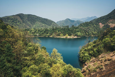 Scenic view of lake and mountains against sky