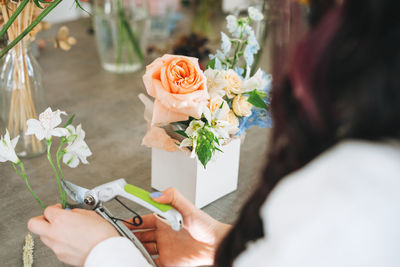 Midsection of woman holding rose bouquet