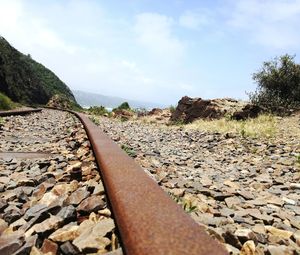 Railroad track amidst trees against sky