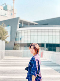 Side view of woman standing on city street