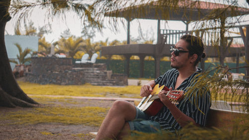 Man playing guitar in park