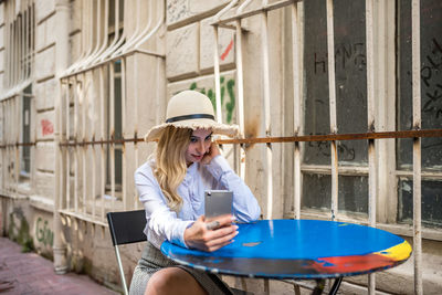 Full length of woman using mobile phone