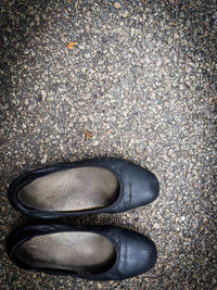 High angle view of black shoes on street