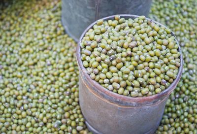 Mung beans in container on sack for sale