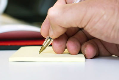 Close-up of hand holding paper