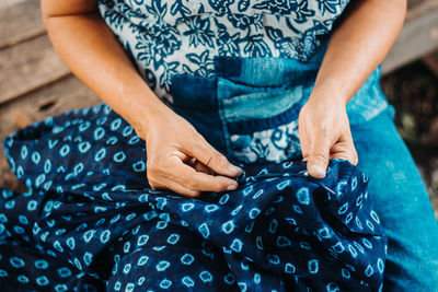 Midsection of woman holding hands