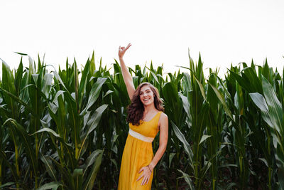 Portrait of smiling young woman standing on field