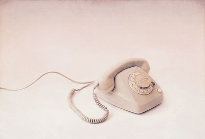 Close-up of telephone over white background