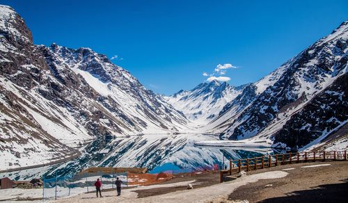 Scenic view of snowcapped mountains against clear blue sky