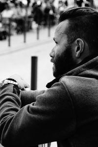 Side view of young man using mobile phone