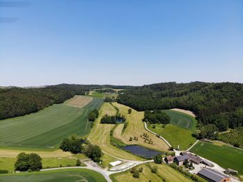 High angle view of golf course against clear sky