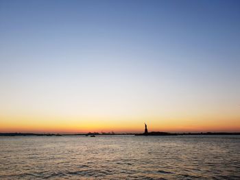 Scenic view of sea against clear sky during sunset