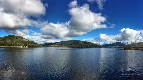 View of calm lake against cloudy sky