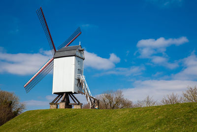 Windmill under a beautiful blue winter sky just before spring at the historical bruges town