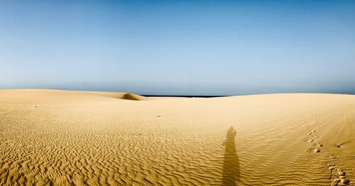 Scenic view of desert against clear sky