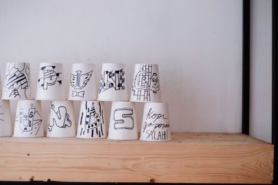 Upside down cups with drawing against wall