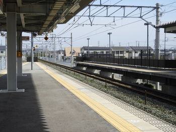 Train at railroad station against sky