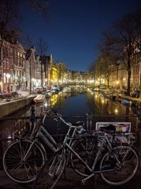 Bicycles parked in canal at night