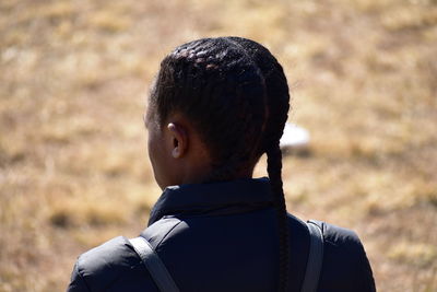 Rear view of man looking away on field