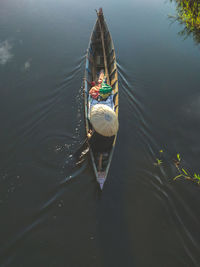High angle view of man sitting in boat on lake