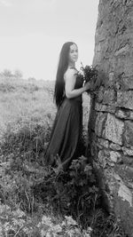 Young woman standing on field