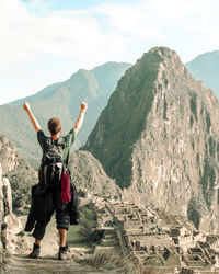 Rear view of man standing on mountain