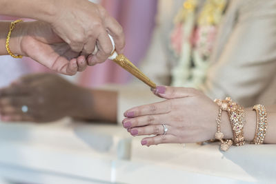 Close-up of hands holding cross