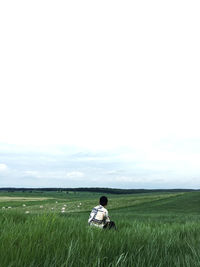 Man standing on field against sky