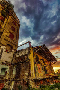 Low angle view of abandoned building against sky