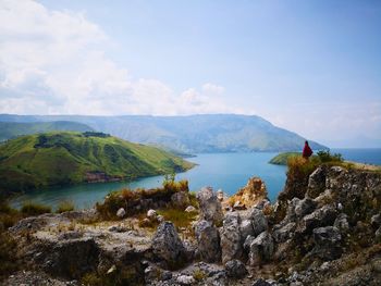 Woman on mountain against sky