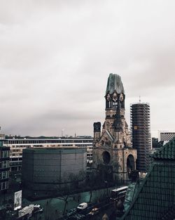 Buildings against cloudy sky