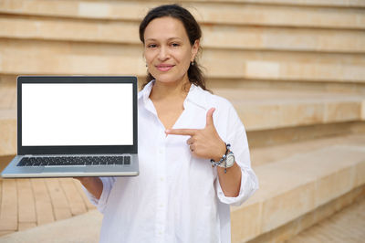 Portrait of young woman using digital tablet