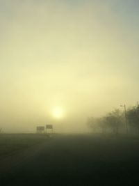 Scenic view of field against sky during foggy weather