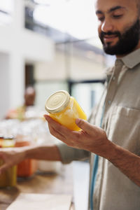 Midsection of man drinking glass