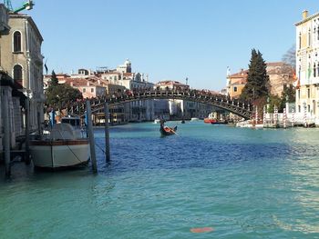 Boats in river with buildings in background