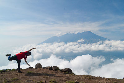 Man with mountains against sky