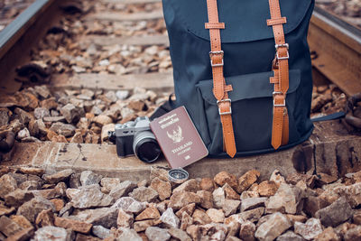 Backpack with camera and passport on railroad tie