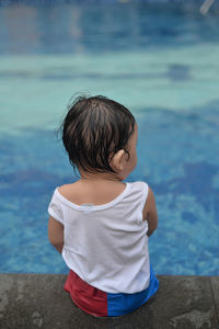 Rear view of girl in water