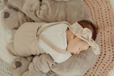 Cute baby girl sleeping on bed at home