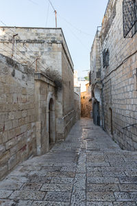 Empty alley amidst buildings in city